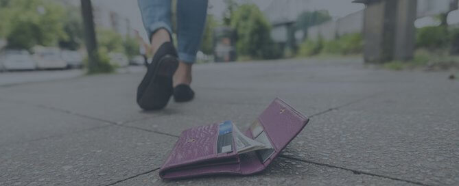 A wallet on the ground and person walking away