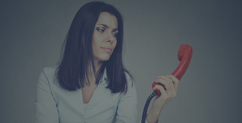 A woman holding a red phone.