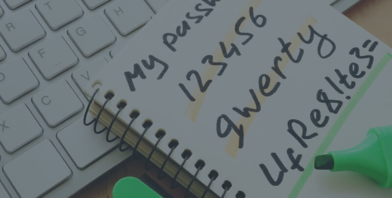 A notepad on a keyword filled with written passwords