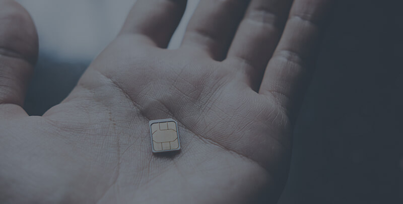 A hand holding a EMV chip