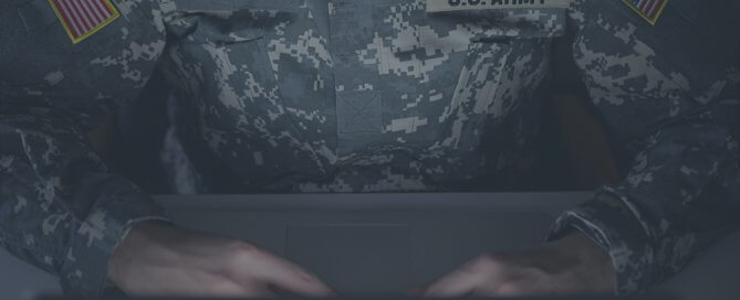 A Army official using a computer laptop.