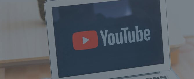 A computer with YouTube logo on the screen.
