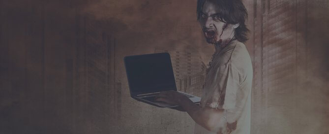 A zombie person holding a laptop.
