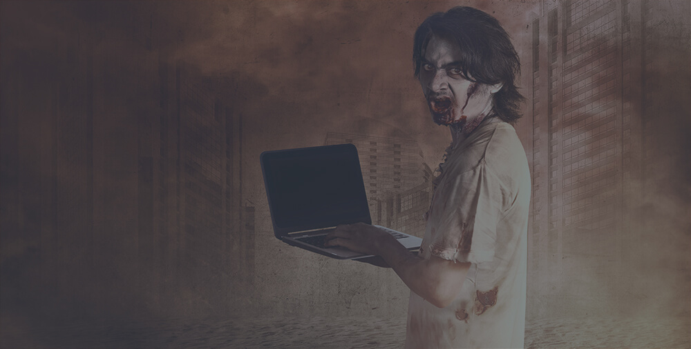 A zombie person holding a laptop.