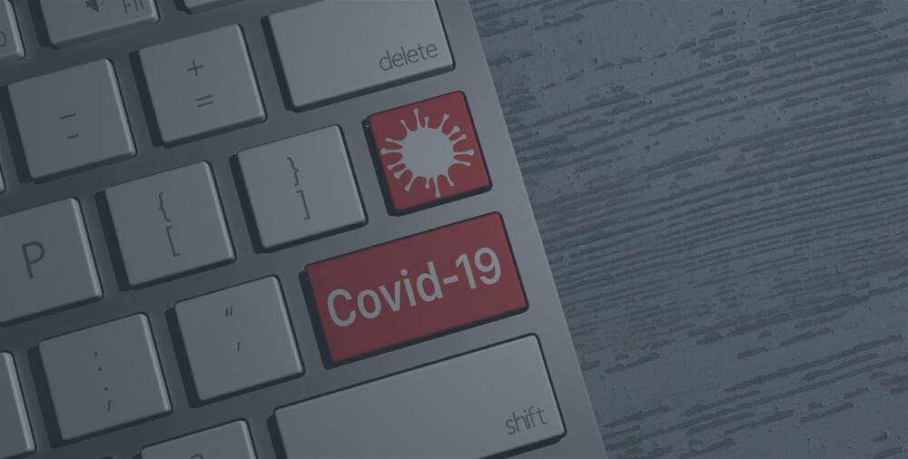 A keyboard with two red covid-19 keys.