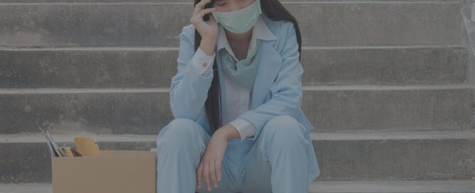 A girl siting on the steps wearing a face mask