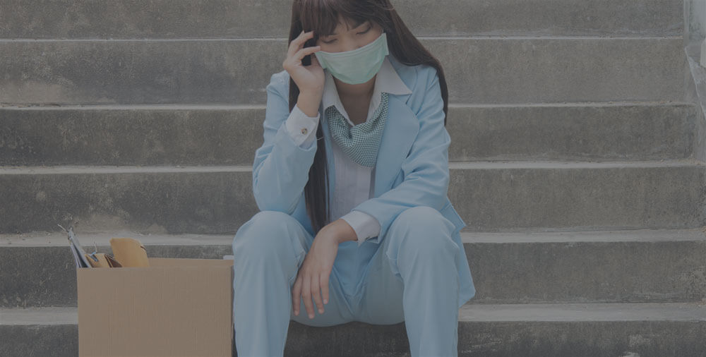 A girl siting on the steps wearing a face mask