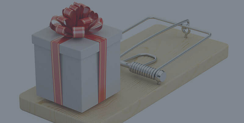 A present on top of a mouse trap.