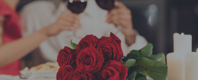 A bouquet of red roses on a white table.