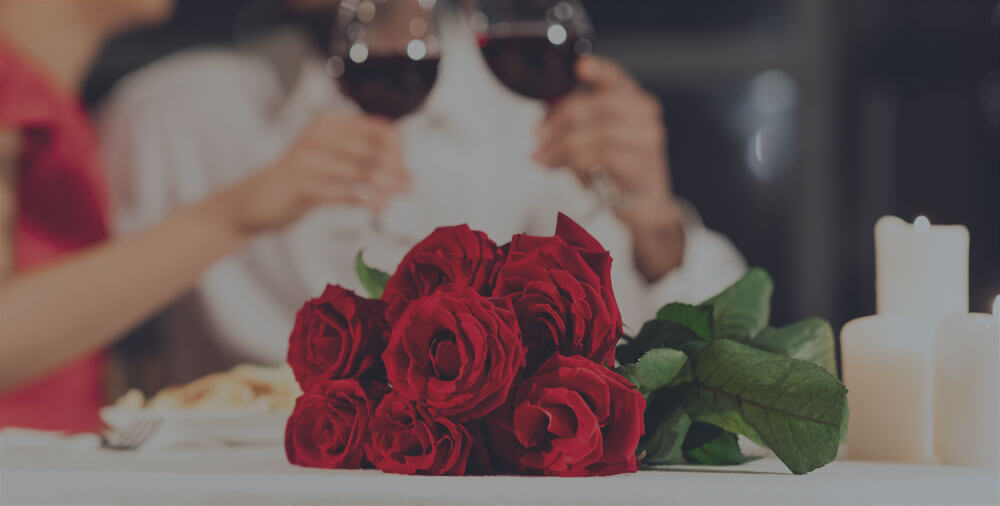 A bouquet of red roses on a white table.