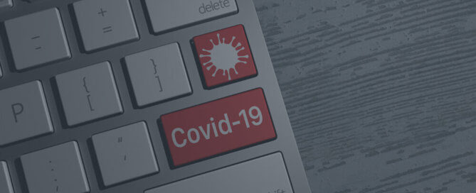 A keyboard with a red covid-19 key