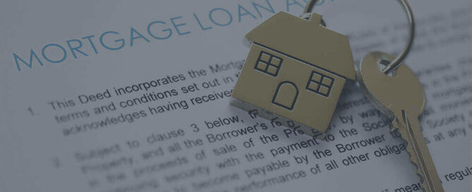 A mortgage loan paper with gold house keys.