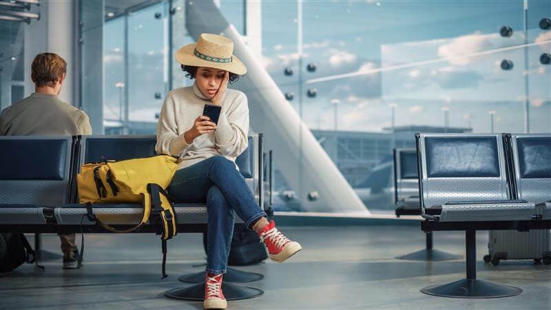 Airport Terminal: Black Woman Waits for Flight, Uses Smartphone, Receives Shockingly Bad News, Misses Flight.