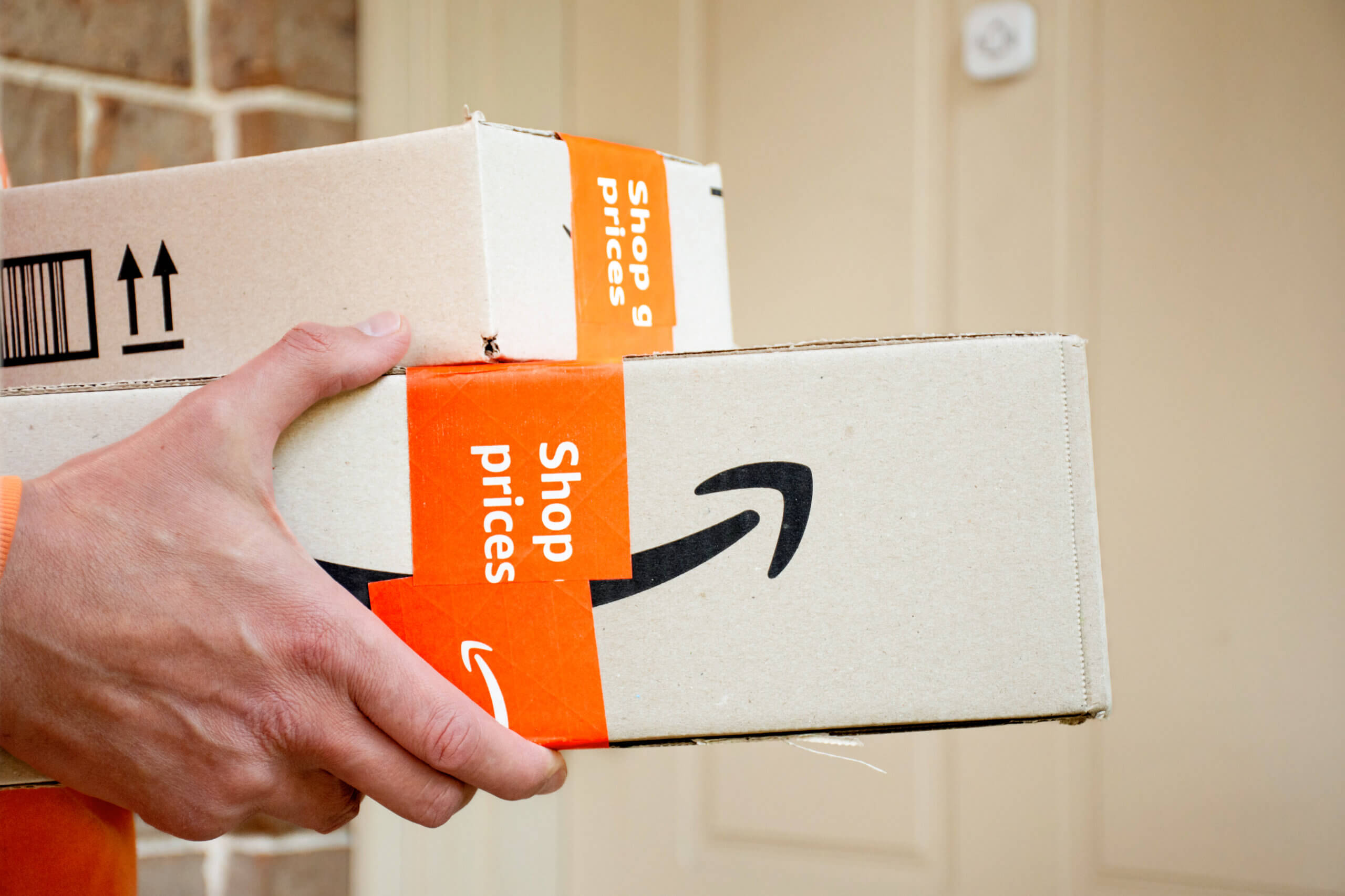 person holding amazon packages