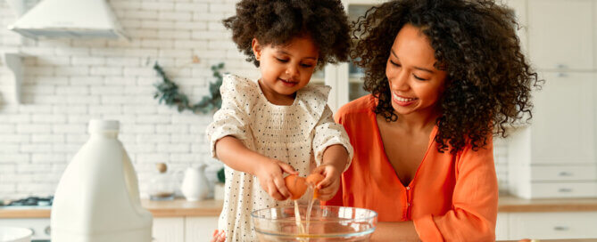 Mom and daughter cooking together in kitchen